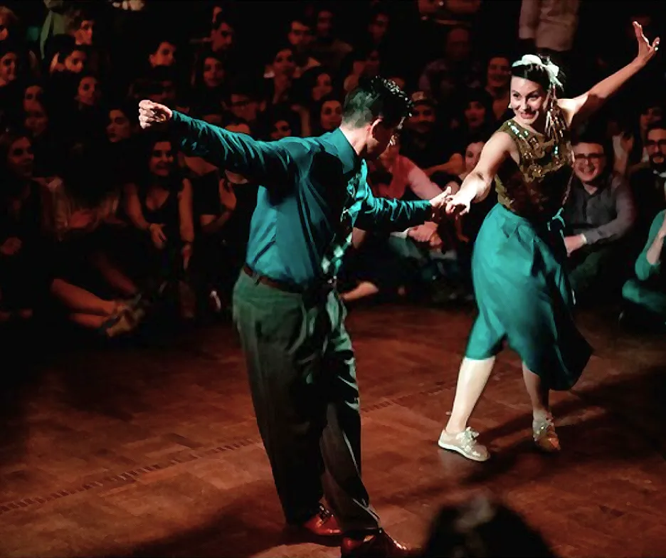 A couple dancing in front of an audience